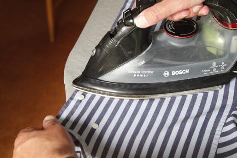 boy finishes by ironing the front