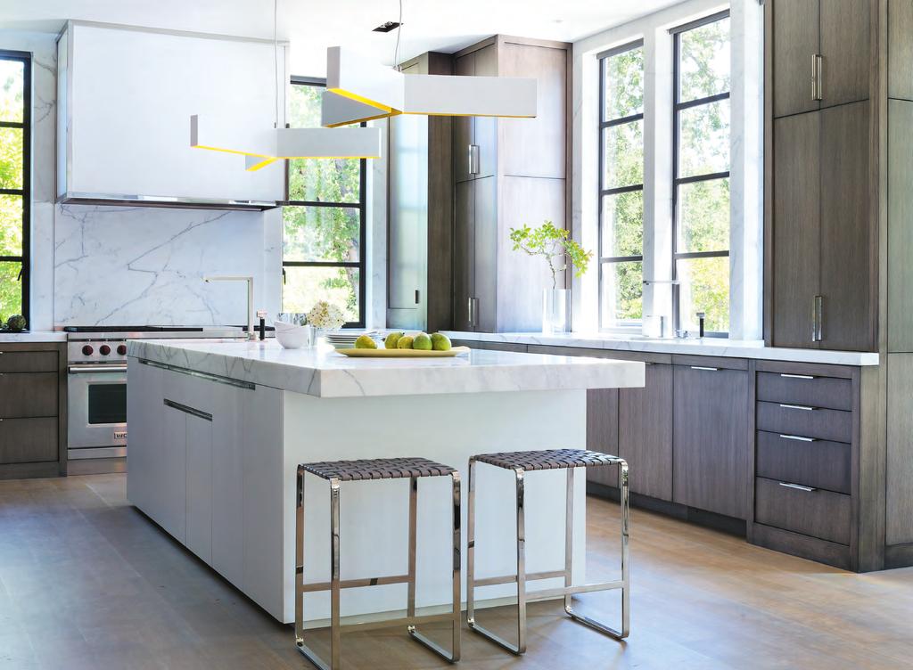 Luxury Ingredients (this photo) Christopher Boots Bucky Block pendants are through the New Black. Backless barstools feature gray leather straps and polished stainless frames.