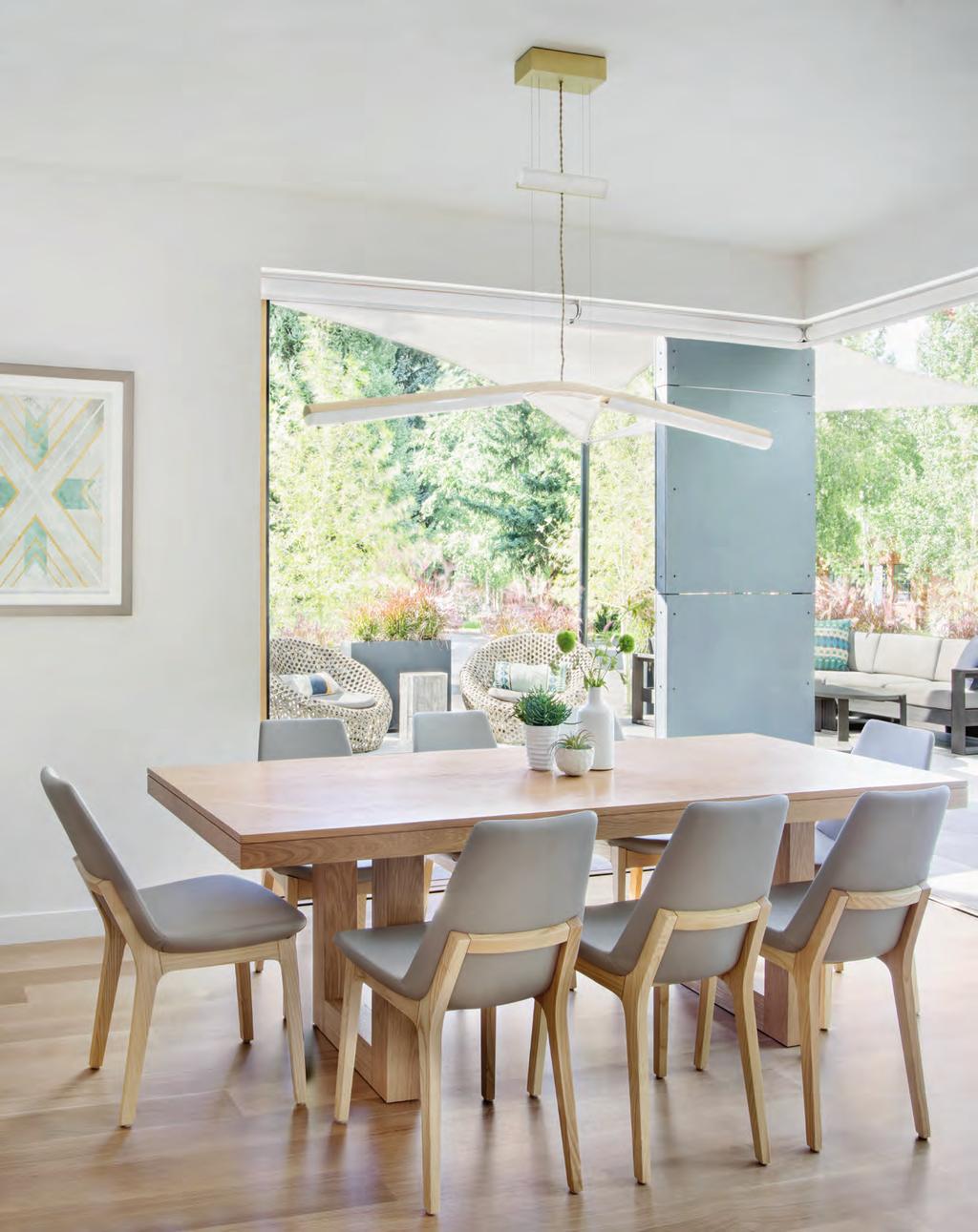 The dining area ties to the terrace via glass doors by Pacific Architectural Millwork that pocket into the walls.