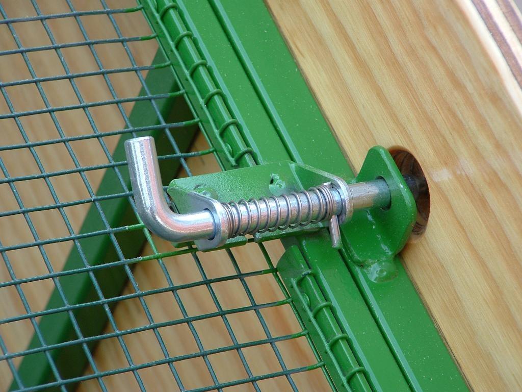 Rotate the handle slightly to release the locking pin, and allow the latch to engage the catch on the cage as shown in the photo on the right above.