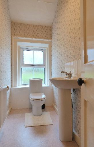 cupboard, heated towel rail. Separate w.c.: Comprising wash hand basin, w.