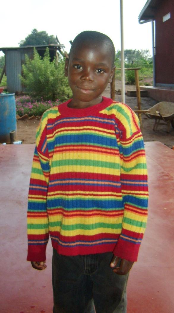 John had no language when he came to the orphanage 3 months ago. The day I was to leave he proudly showed me his colourful jumper and a book.