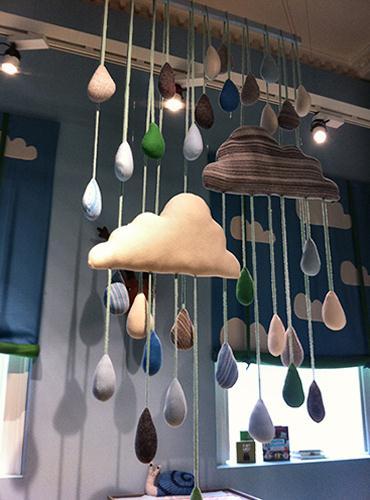 throws, with a giant mobile of rainclouds hanging in
