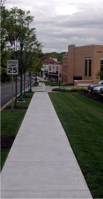 Maintain a line of building facades and storefronts to define the sidewalk edge.