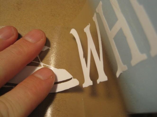 Now, very slowly peel the wax paper from underneath the decal, ensuring the