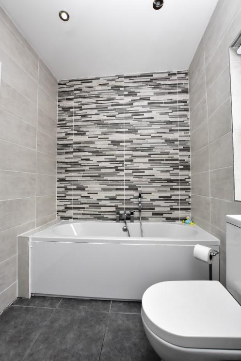 Fully tiled corner shower cubicle with