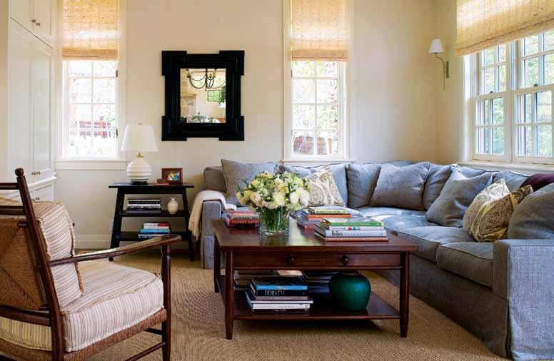 FACING PAGE: Natural fibers add texture and a casual vibe to the family room. Linen by Jasper Fabrics covers the JJ Custom sofa; the rug is sisal and the woven wood window coverings are by Conrad.