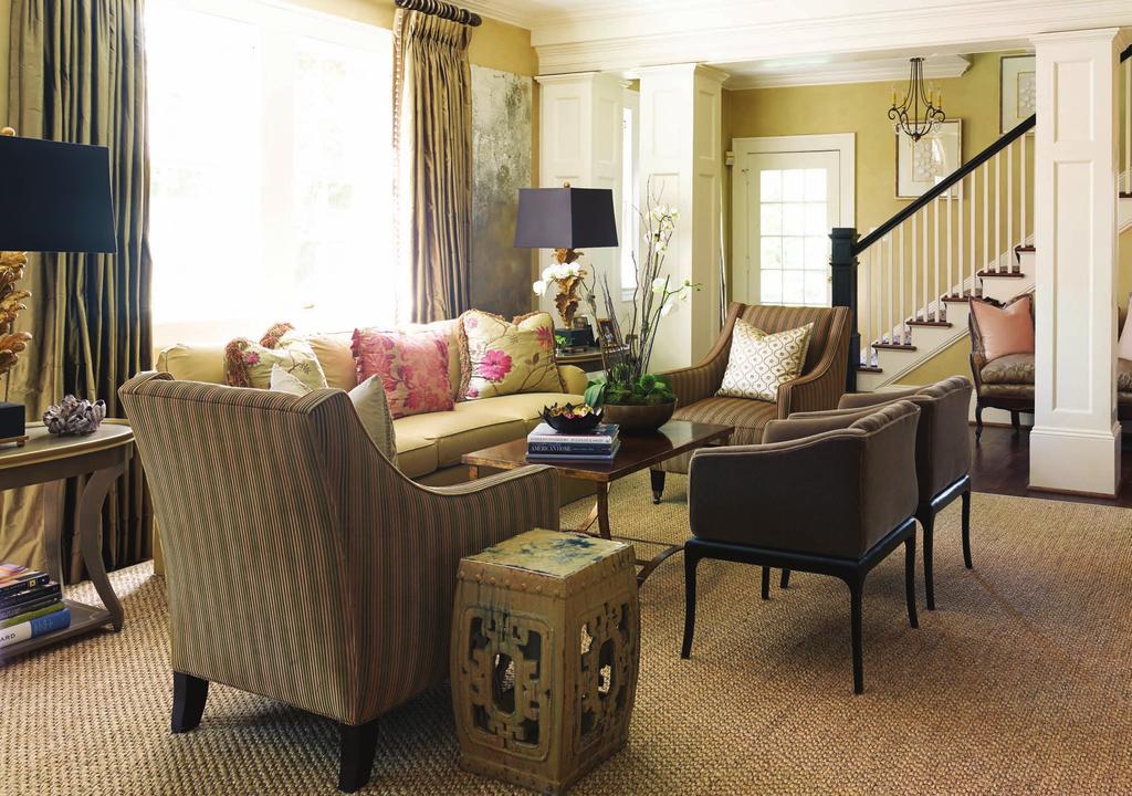 Laura s warm, neutral color palette is enlivened with dark wood and bronze accents, and shades of pink.