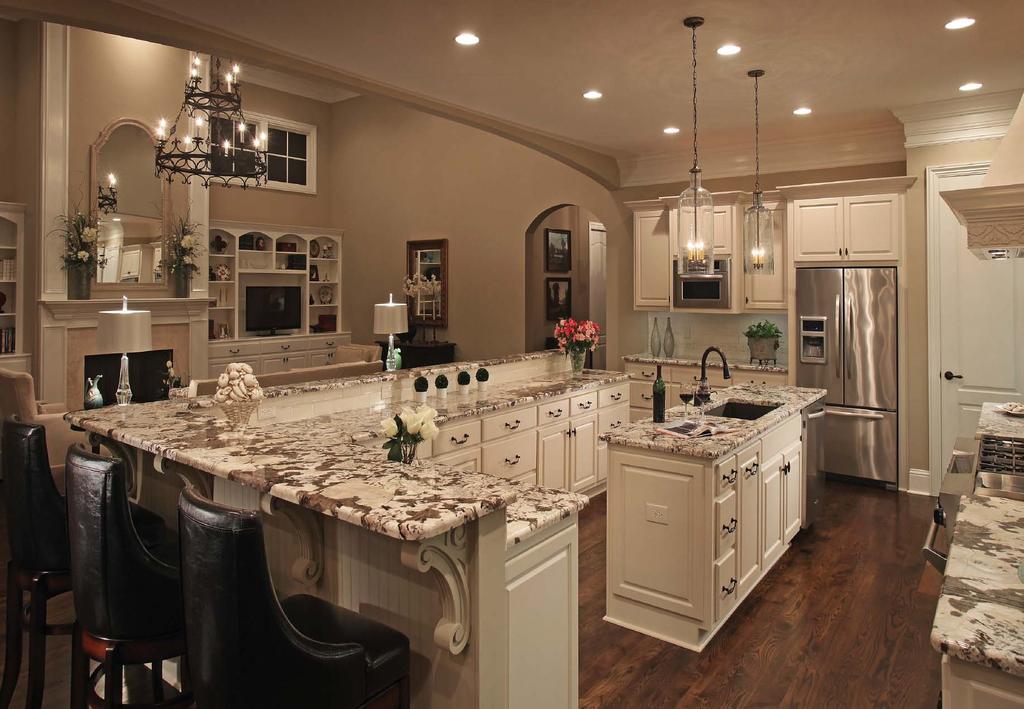 EUROPEAN FLAIR IN MONTGOMERY The kitchen s dark-stained hardwoods, and bronze plumbing and cabinet hardware, provide a pleasing contrast to the neutral tones.