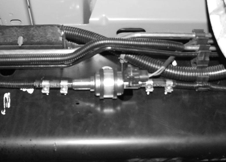 Insert fuel line () into rubber fuel line adapter (3) until it bottoms out against nipple and secure with clamp (). Fig.