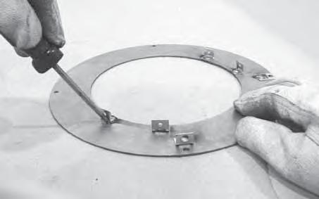 Bend the heat shield as shown. CAUTION Sharp Edges Wear protective gloves and safety glasses during installation. Figure 4.
