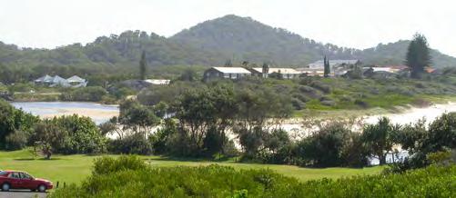The view shows how the settlement is surrounded and contained by vegetation; buildings are nestled within nature, with nature dominating built form. Vegetation meets water, sand and sky.