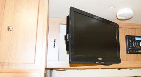 NOTE: The 12-Volt TV Master Power switch must be ON to operate the TV. To Swivel TV Grasp the inboard side of TV and disengage from the wall mounting bracket.