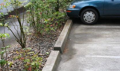 An 18-inch minimum width open curb is a good standard to accept stormwater flow.