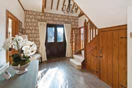 To the ground floor you will find a third double bedroom and a large sitting room with wood burning stove which has double doors leading directly to a fine dining room.