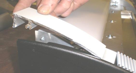 Pull down the front cover. Place approximately half of the adhesive pellets in the front of the tray.