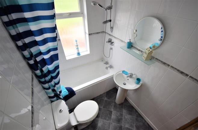 This beautiful family bathroom provides a panelled bath, a low level w/c, hand wash basin an
