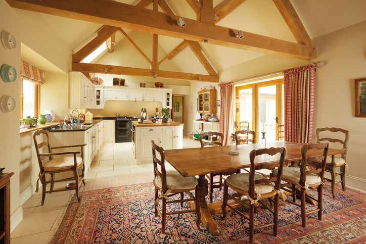 With striking exposed A frames, the family area has a working wood burner, the kitchen area has a four oven Aga, ceramic hob, oven with microwave and dishwasher.