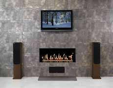 Its central feature is a modulating single ribbon of living flame that dances above a bed of white stones or through a realistic log-effect display, which boasts increased efficiency due to a special
