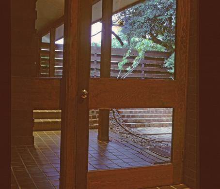 Right: The entry court with screen fence, as seen from inside the front door.