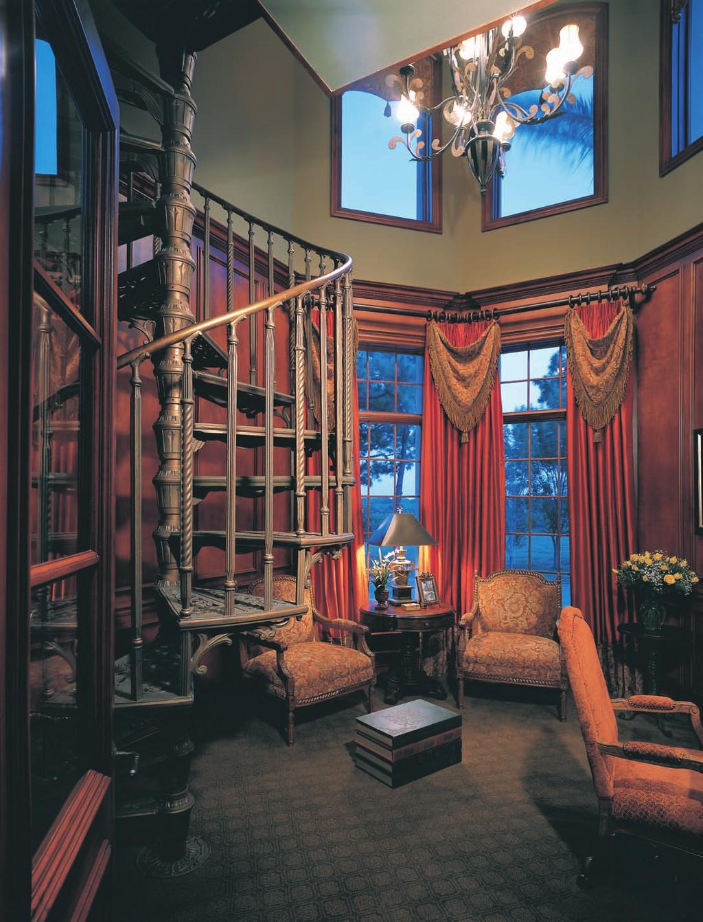 A wrought-iron spiral staircase leads from the two-story