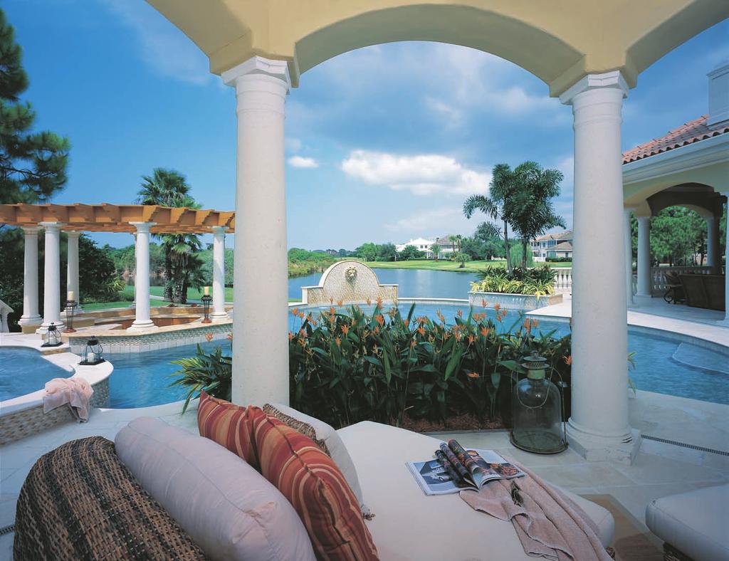 The lanai enjoys a view of the pool with its pergola over the bar area, as well as the lake behind the home.