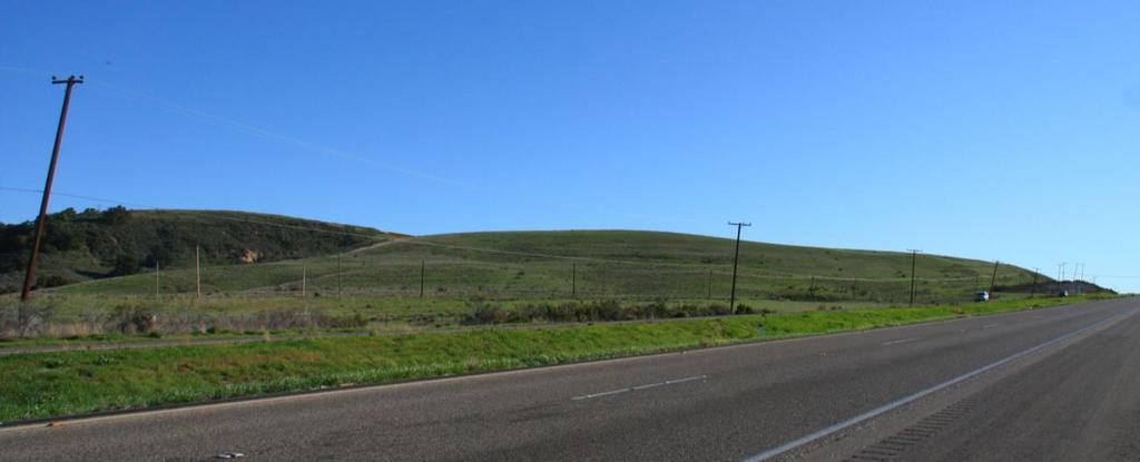 Existing View - depicts a northeasterly view of the rolling grassland-covered hills of proposed Parcel 7 as experienced by passing motorists traveling southbound on U.S. Highway 101.