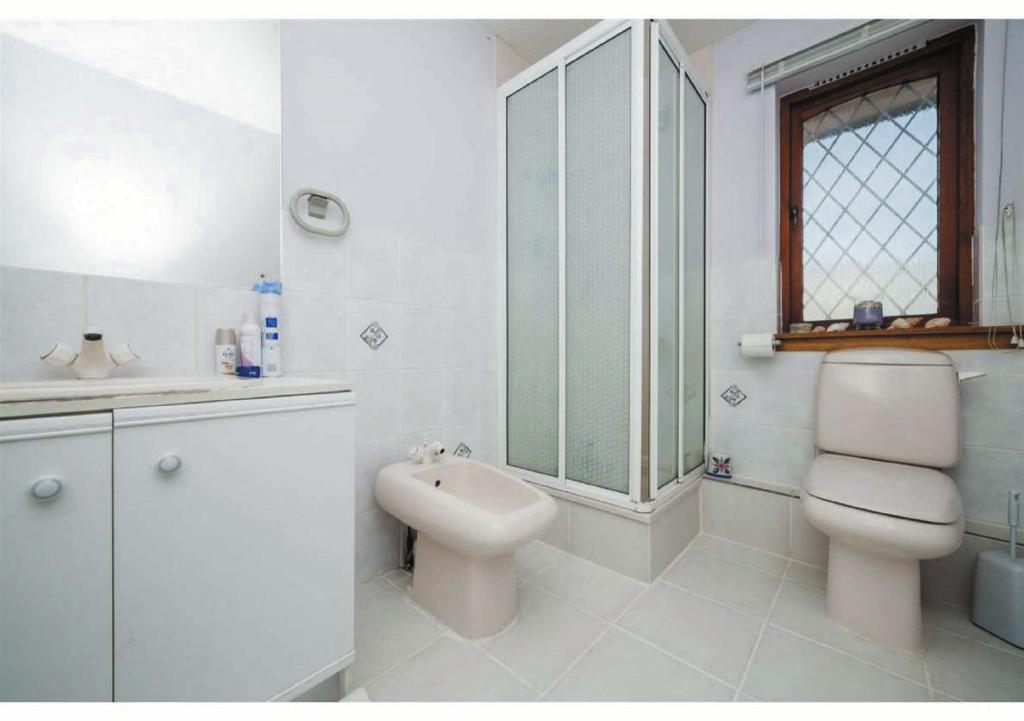 Cloakroom This room consists of a two piece suite comprising of wall hung wash hand basin and close coupled WC. The ceiling is fitted with a flush ceiling light. A radiator provides warmth.