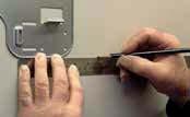 Step. Using a level, verify the mounting plate is horizontal and mark the