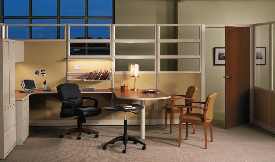 Initiate s 81" panels and metal-frame doors let you create a private office virtually anywhere. Panels: Aeon Wheat fabric and Tan finish. Worksurfaces: Bourbon Cherry laminate top with Tan edge.