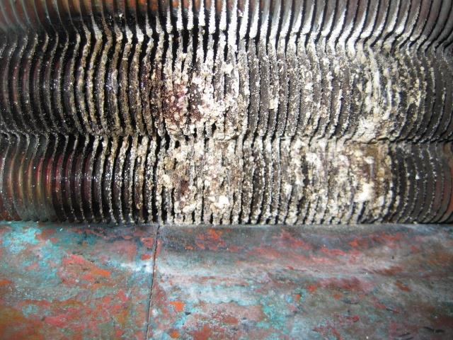 Bottom of Heat Exchanger Used heat exchanger with signs of hard water scaling definitely evident from scale