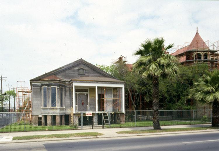 Figure 9: Quigg-Baulard Cottage and Willis-Moody Mansion, both with scaffolding during restoration in 1987;