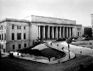 Doric columns stretch across the Union Depot s front façade and up to the second story level. A landscaped lawn and circular drive are in the foreground.