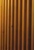The longitudinal walls, designed out of deep vertical wooden slats, convey a spatial boundary through a physically permeable wall but interfering with the space