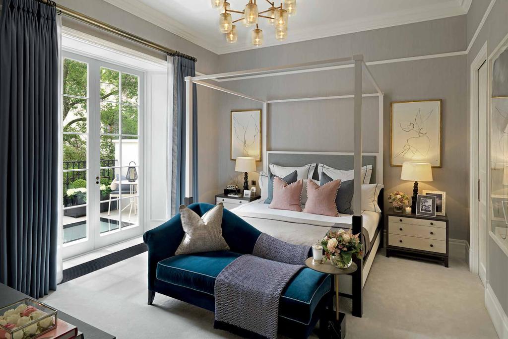 Dressed tastefully with luxurious fabrics in neutral tones, the master bedroom is calming and full