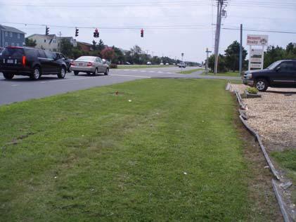 strip within the right of way. A storm sewer runs along this right-of-way with periodic drop inlets located to collect the runoff. The grassed area is at least 20 feet wide in most areas.
