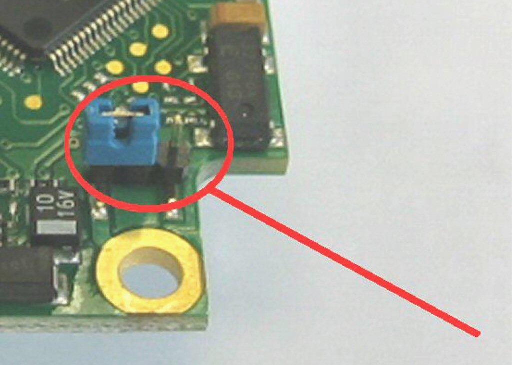 Ground Connection At the bottom side of the mainboard PCB you will find a connector (jumper) which has been placed from factory side as shown in the picture [left and middle pin connected].