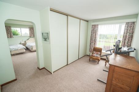 SIDE HALLWAY Fitted cloak rails; storage cupboard; leading to:- CLOAKROOM 2.44m (8'0) x 1.