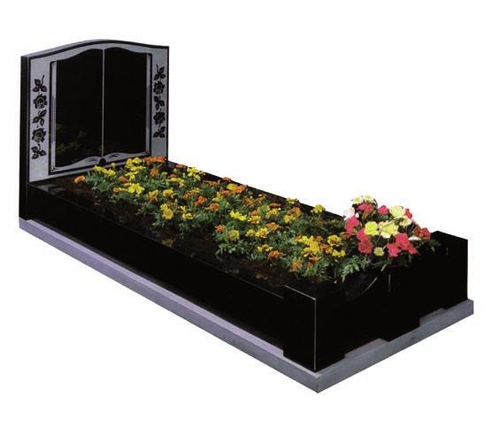 An upright book headstone with hand carved roses. This has kerbs and two posts.