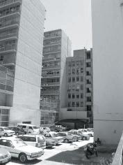 The site announces a sudden gap in the urban fabric, with a dense population of parked cars on the erf in the otherwise cohesive facade of the rest of the city block between Paul Kruger and Andries