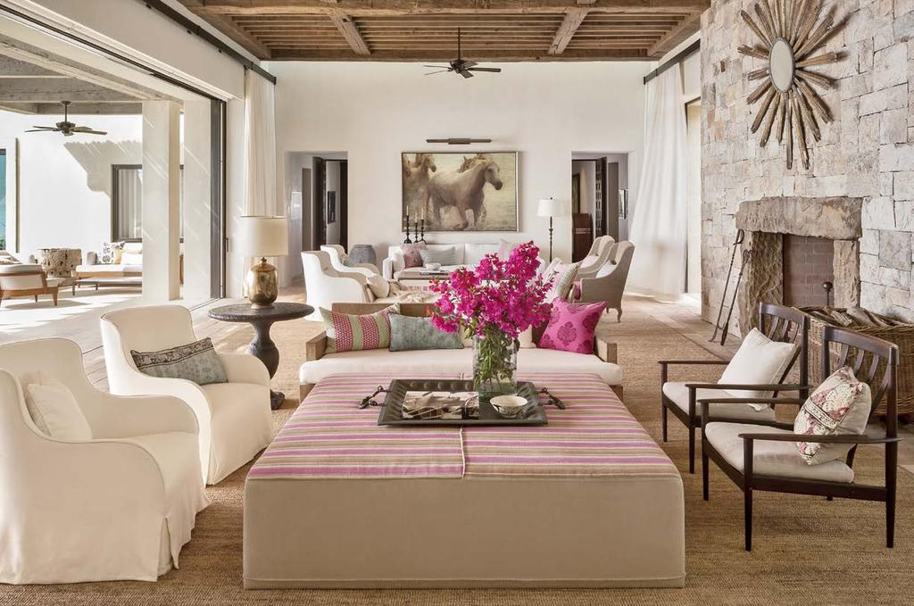 The custom sofa uses Chris Barrett Textiles; throw pillow covers are Carolina Irving and vintage fabrics. Gregorius Pineo lounge chairs feature Holly Hunt fabric.