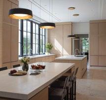 The striking kitchen is outfitted in floor to ceiling rift sawn oak slab cabinetry