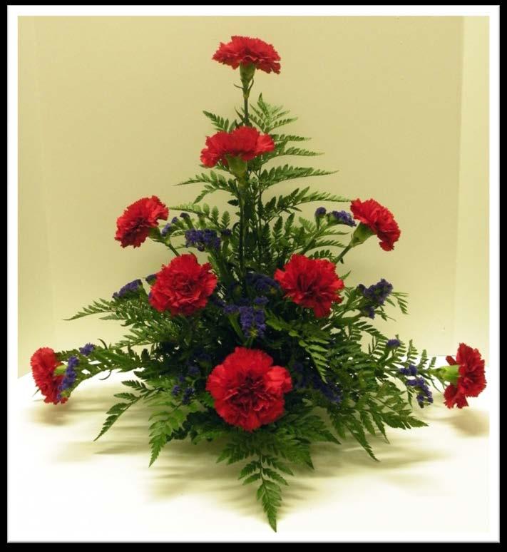 The Completed Arrangement Completed arrangement with flowers, foliage and filler The photo shows depth created by the filler and