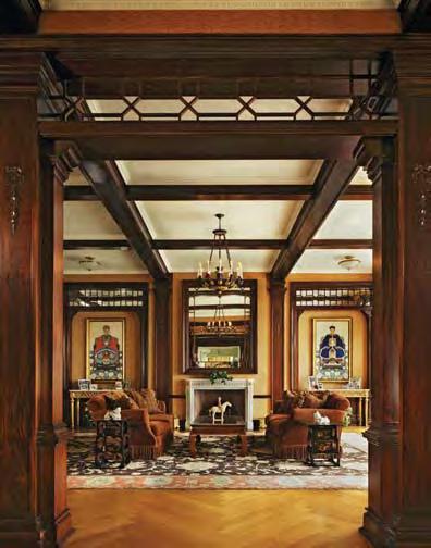 LEFT The family room s mahogany beams trace the ceiling while the coffers were painted to appear light. BELOW The dining room is decorated with hand-painted Chinese wallpaper from Gracie and Sons.
