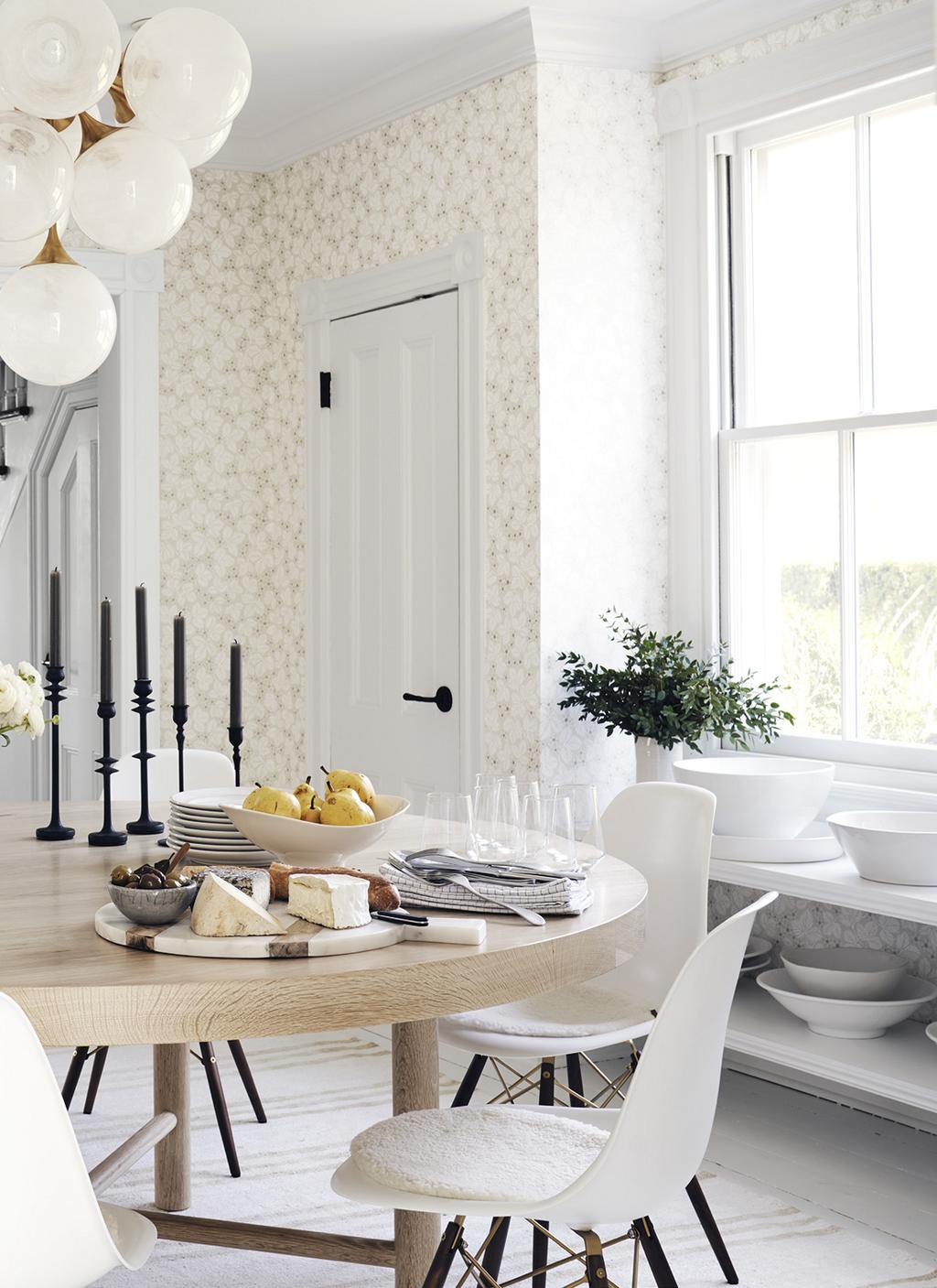 Designer Liliane Hart transformed a seaside Victorian home in Sag Harbor, New York, with Scandinavian touches, including this dining room wallpapered in a strawberry-plant print by the Swedish brand
