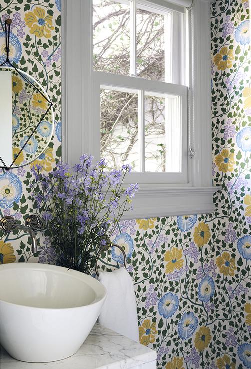The home s most adventurous color happens in the powder room, which has a blossom-splashed