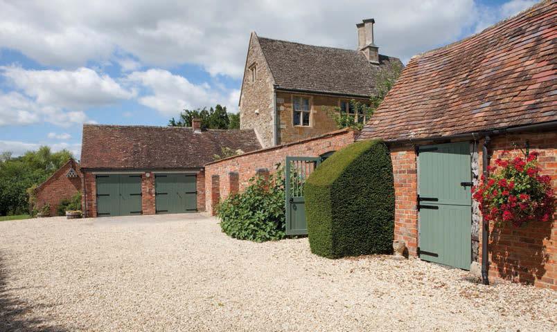 A brick and tiled double garage with doors onto the entrance/stable courtyard and a