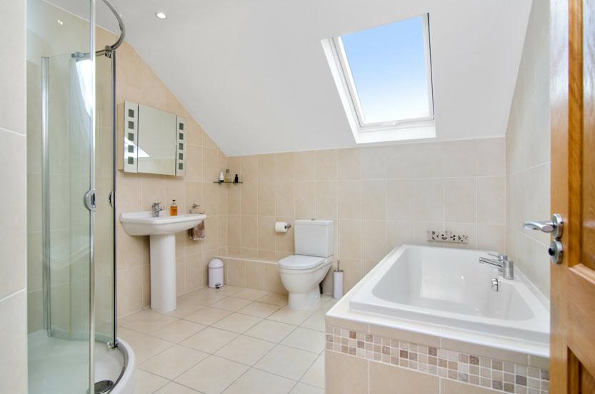 FULLY TILED BATHROOM: Bath with tiled surround, low flush wc, pedestal wash hand basin, corner shower cubicle, low voltage
