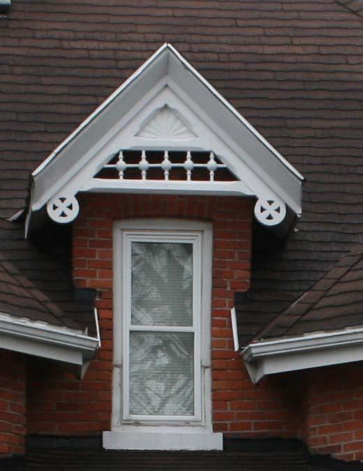 APPENDIX B Slightly arched brick headers over window openings Decorative bargeboard gable trim incorporating carved sunbursts in the gable peaks and pierced