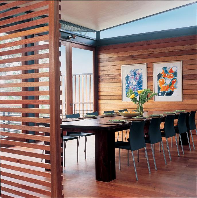 LEFT, FROM TOP The balau wood-clad wall in the dining area is echoed by the slatted wooden screen opposite. Contemporary furnishings add to the pared-down aesthetic.